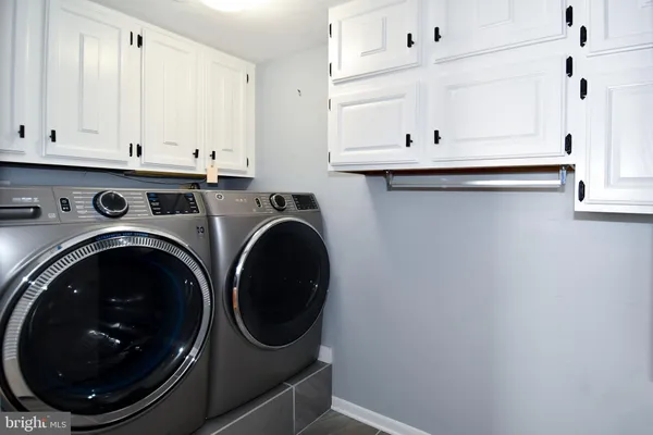 a utility room with sink dryer and washer