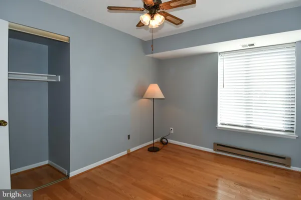 a view of a room with wooden floor and a window