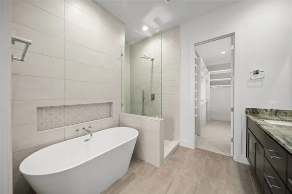 a bathroom with a tub shower and sink