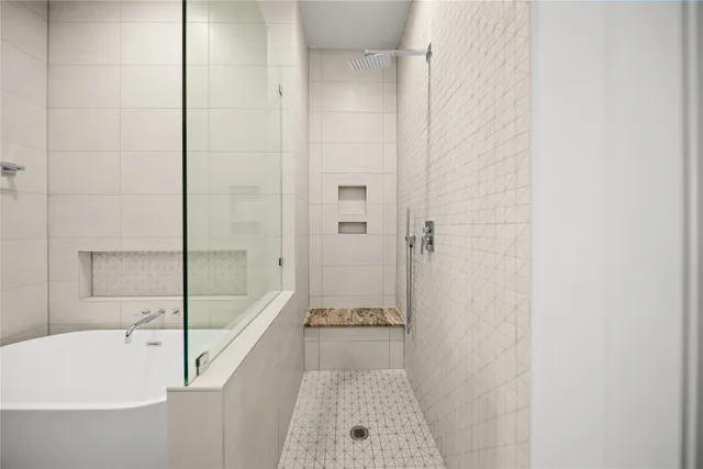 a bathroom with a tub shower and sink