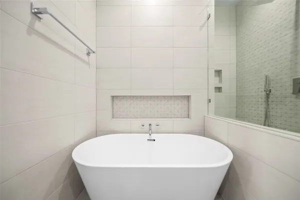 a white bath tub sitting in a bathroom