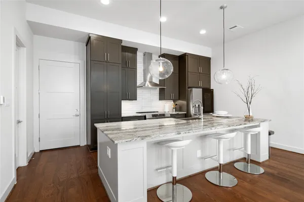 a kitchen with kitchen island a counter space a sink and appliances