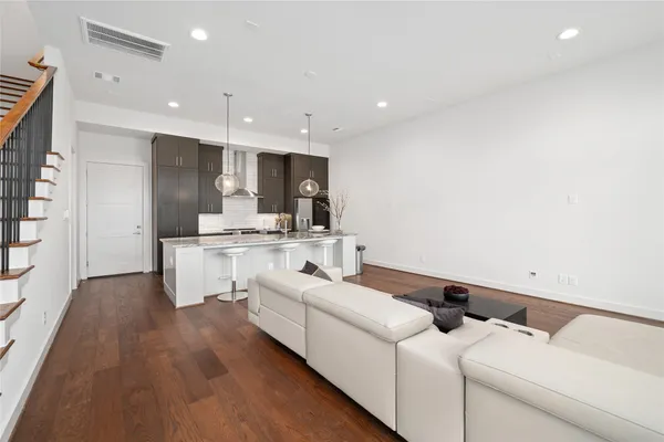 a kitchen with a sink cabinets and wooden floor