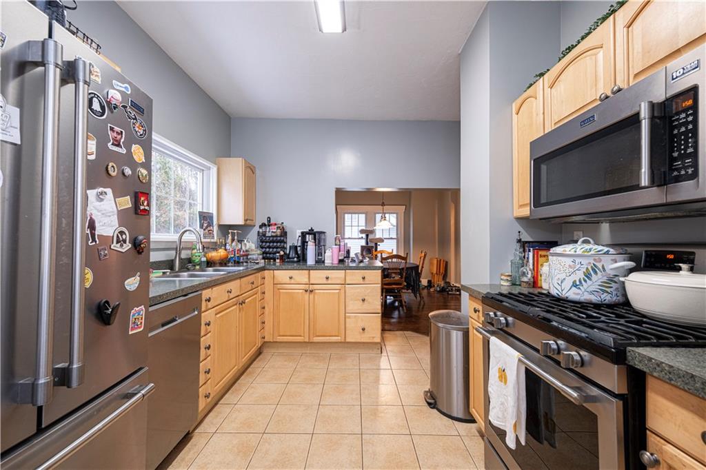 4263 Evergreen Road Pittsburgh, PA 15214 - Photo 11 of 24 a kitchen with stainless steel appliances granite countertop a stove and a sink