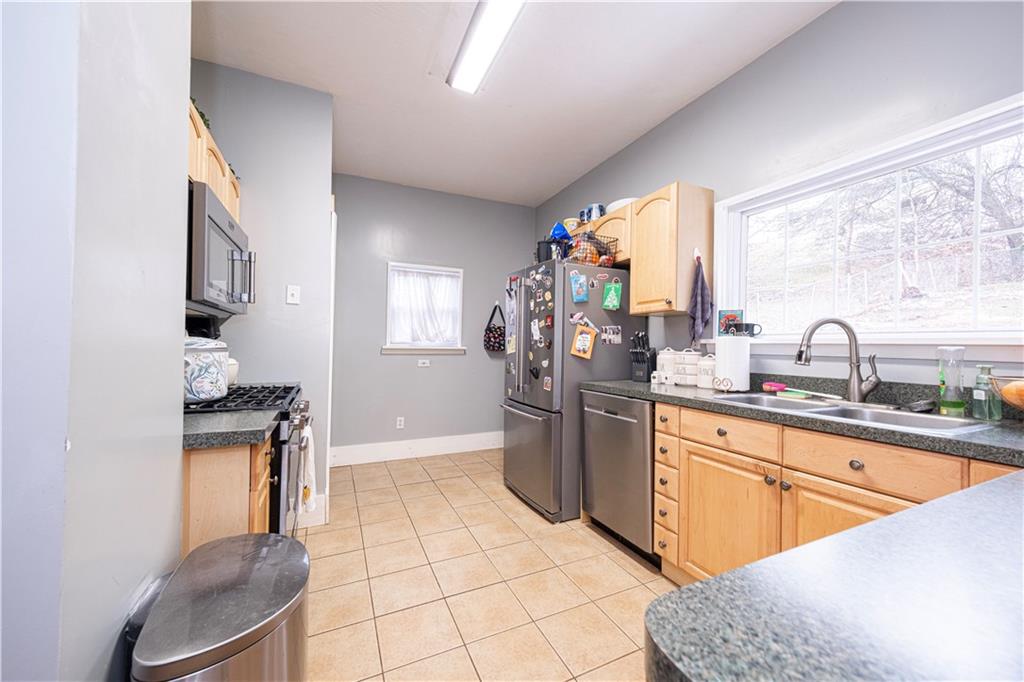 4263 Evergreen Road Pittsburgh, PA 15214 - Photo 12 of 24 a kitchen with a sink a stove and a refrigerator
