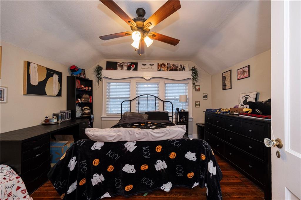 4263 Evergreen Road Pittsburgh, PA 15214 - Photo 13 of 24 a bedroom with a bed and a chandelier
