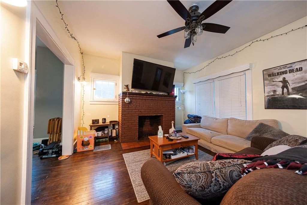 4263 Evergreen Road Pittsburgh, PA 15214 - Photo 5 of 24 a living room with furniture a fireplace and a flat screen tv