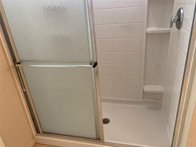 a bathroom with a glass door shower