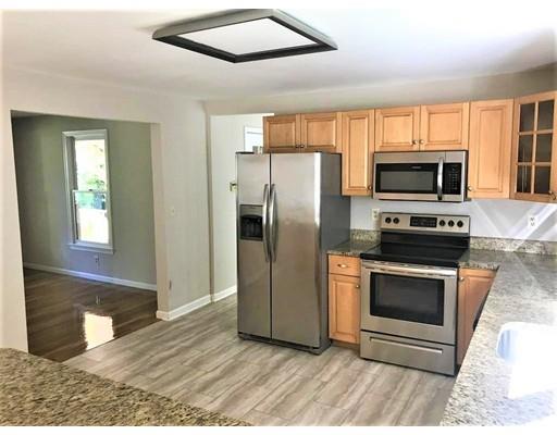 21 Wamsutta Ridge Road Charlton, MA 01507 - Photo 16 of 42 a kitchen with granite countertop a refrigerator and a stove top oven