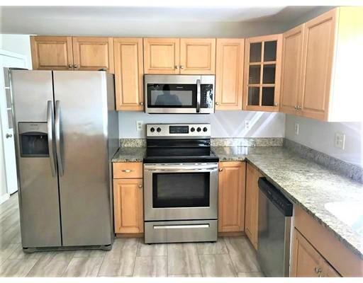 21 Wamsutta Ridge Road Charlton, MA 01507 - Photo 19 of 42 a kitchen with stainless steel appliances granite countertop a stove a refrigerator and a microwave