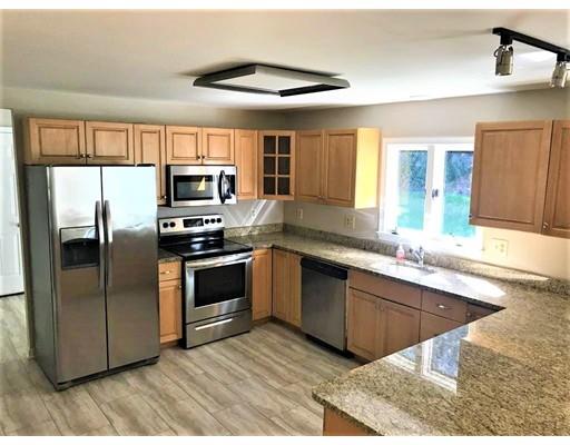 21 Wamsutta Ridge Road Charlton, MA 01507 - Photo 9 of 42 a kitchen with granite countertop a refrigerator and a sink