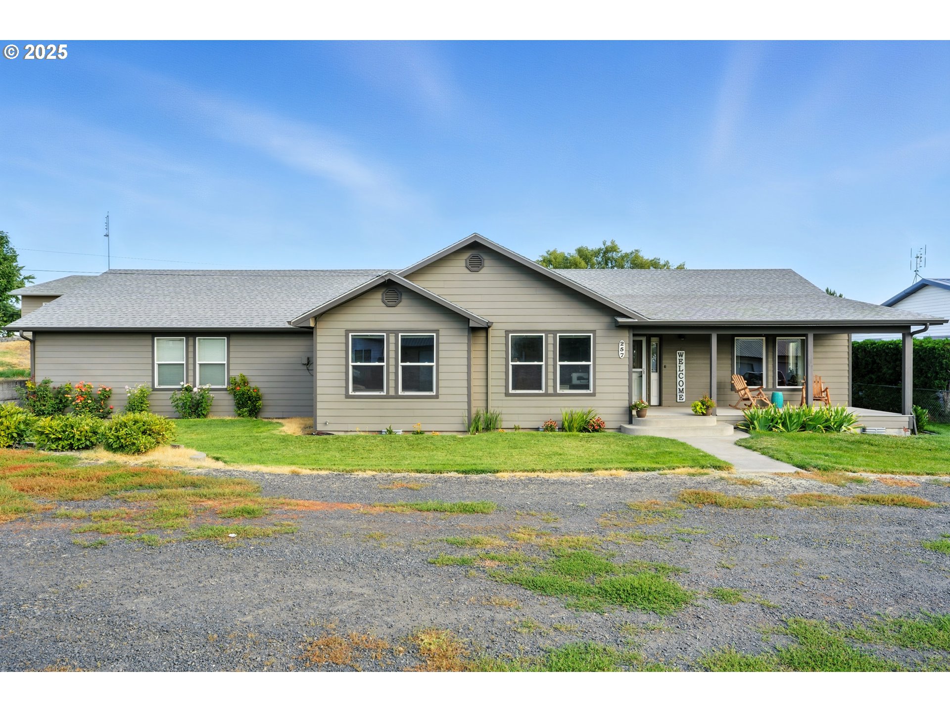 257 West Lincoln Street Athena, OR 97813 - Photo 2 of 37 a front view of a house with a yard and garage