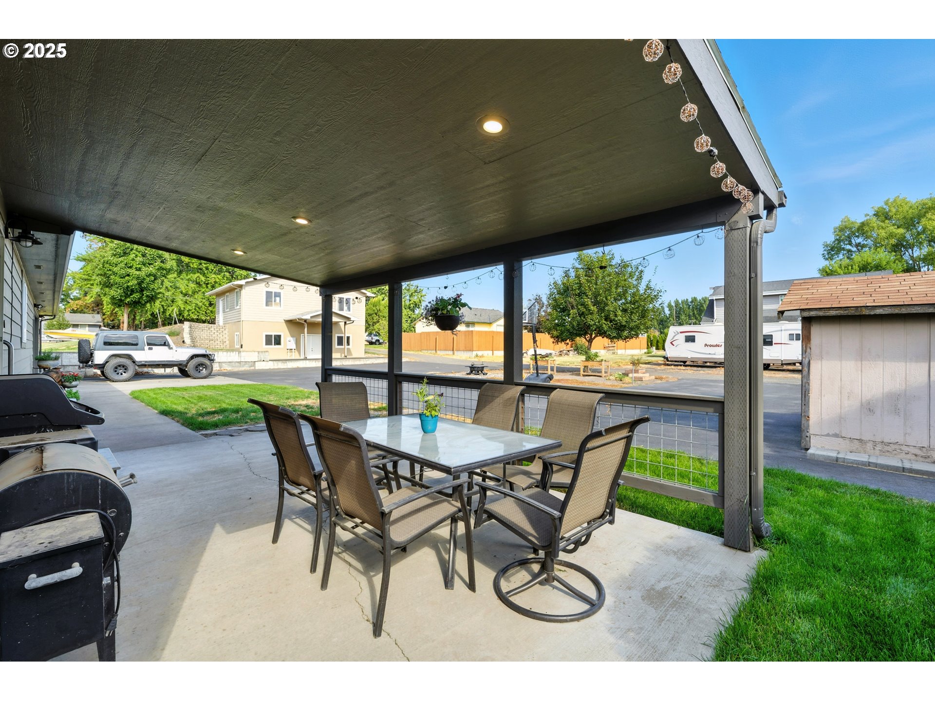 257 West Lincoln Street Athena, OR 97813 - Photo 5 of 37 a view of a patio with a table chairs and a backyard