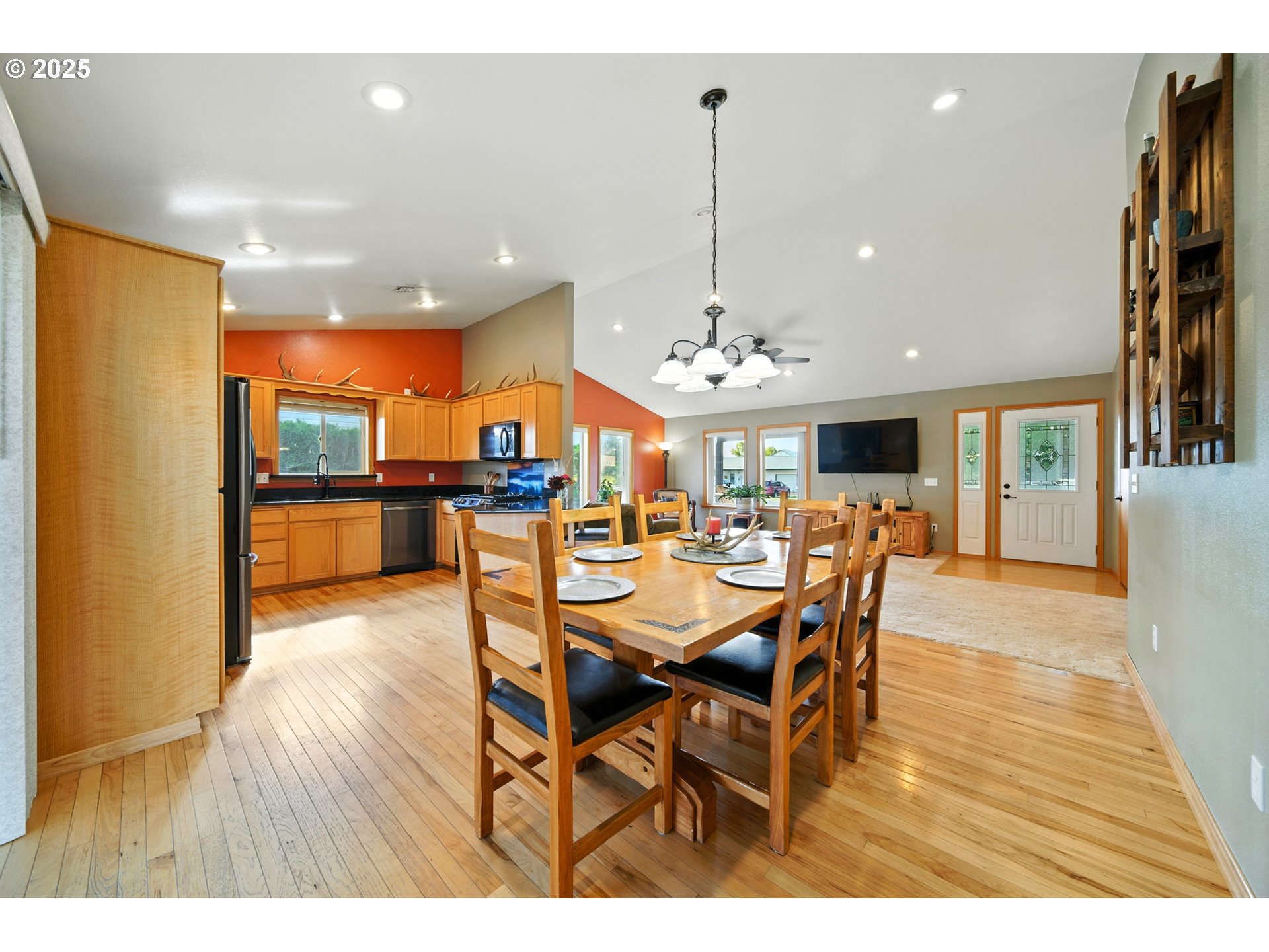 257 West Lincoln Street Athena, OR 97813 - Photo 8 of 37 a view of a dining room and livingroom with furniture wooden floor a rug a painting and a chandelier