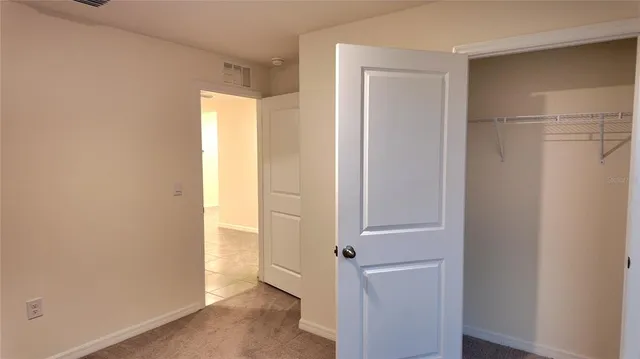 a bathroom with a granite countertop toilet and a sink
