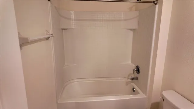 a view of a white house with wooden fence