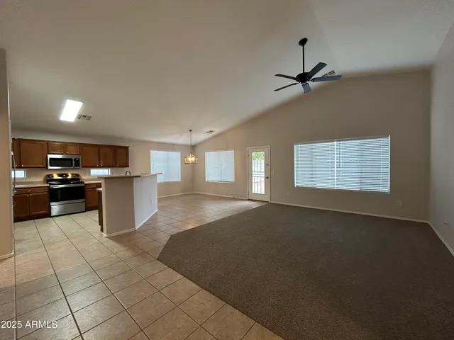 a open kitchen with cabinets and a stove top oven