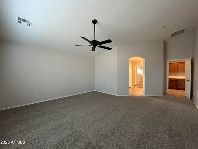 a view of a room with a ceiling fan