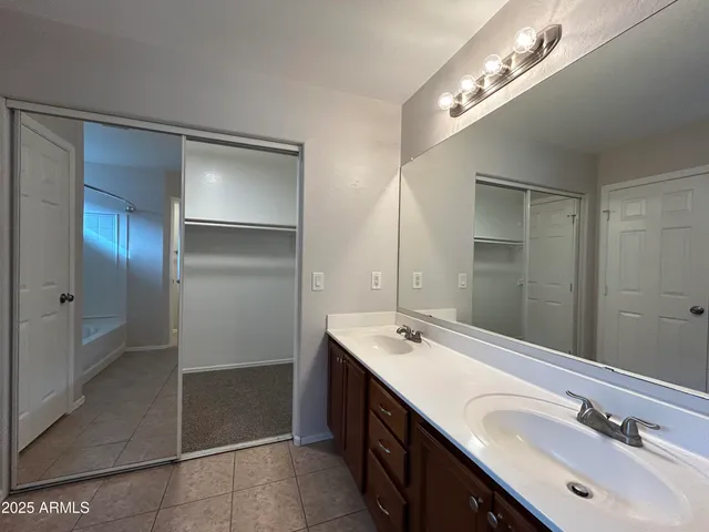 a bathroom with a double vanity sink and a mirror
