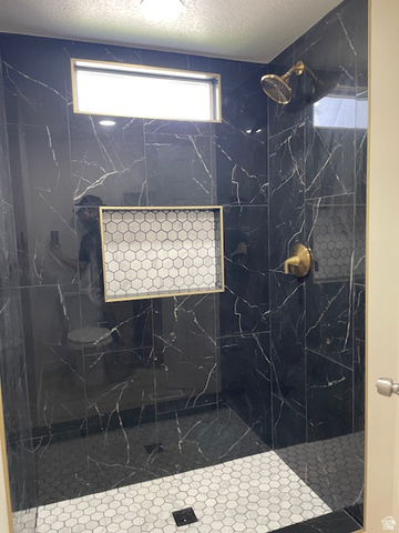 1500 North Angel Street West, Unit 56 Layton, UT 84041 - Photo 15 of 20 Primary Bathroom with a textured ceiling and a marble finish shower