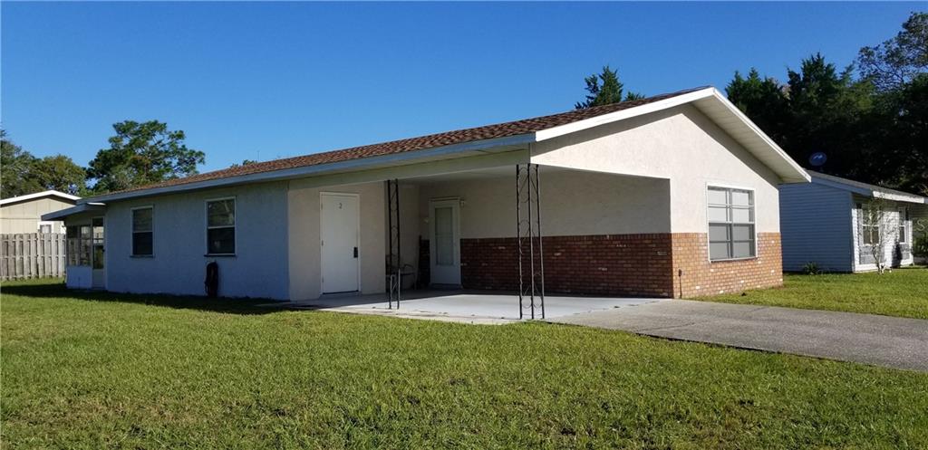 2 Spring Loop Circle Ocala, FL 34472 - Photo 1 of 1 a backyard of a house with potted plants