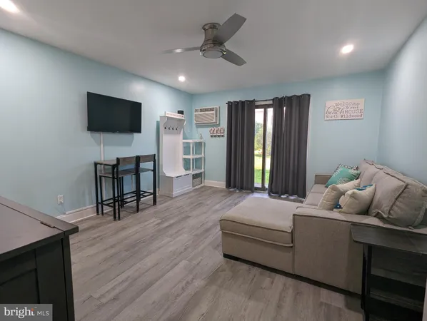 a bedroom with furniture and a flat screen tv