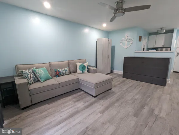 a living room with furniture and a ceiling fan