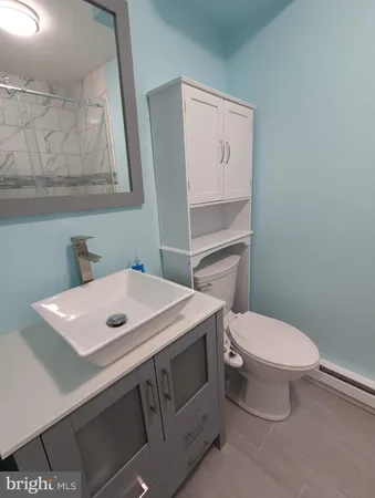 a bathroom with a sink toilet and mirror