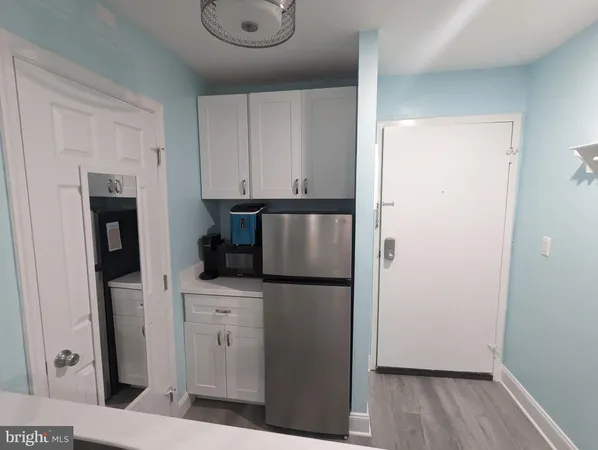 a kitchen with stainless steel appliances a refrigerator and cabinets