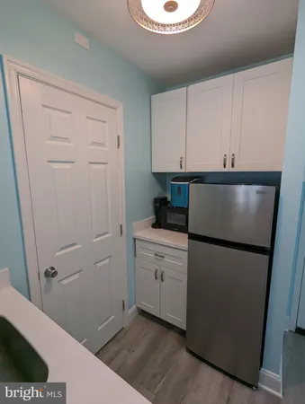 a view of a kitchen with a refrigerator a stove top oven and a refrigerator
