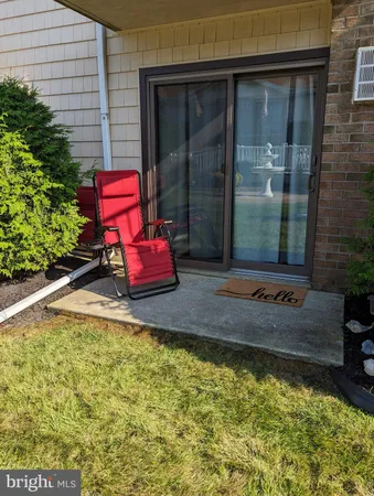 a view of a house with backyard porch and sitting area