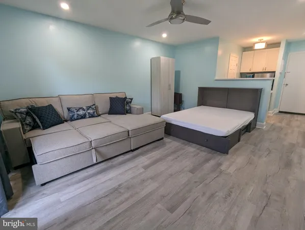 a bedroom with double bed and a couch