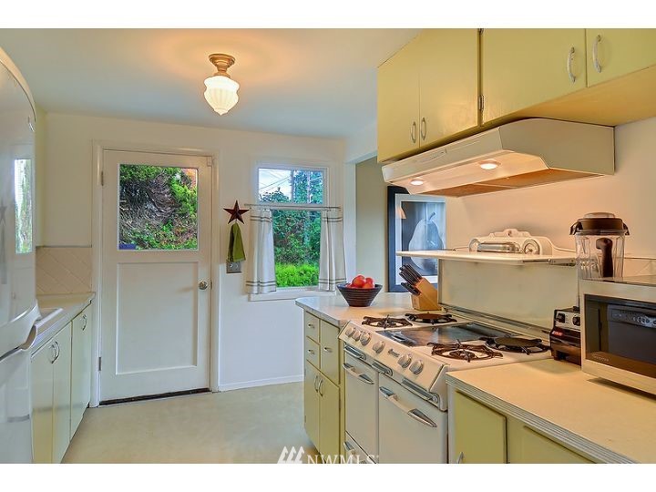 5326 South Hazel Street Seattle, WA 98178 - Photo 6 of 13 a kitchen that has a stove and a microwave