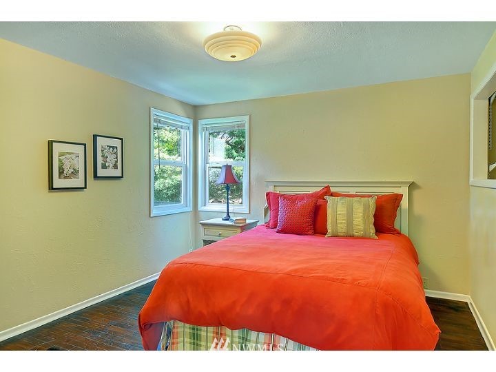 5326 South Hazel Street Seattle, WA 98178 - Photo 7 of 13 a bed sitting in a bedroom next to a window