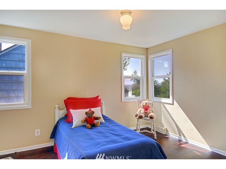 5326 South Hazel Street Seattle, WA 98178 - Photo 8 of 13 a bedroom with a bed and wooden floor