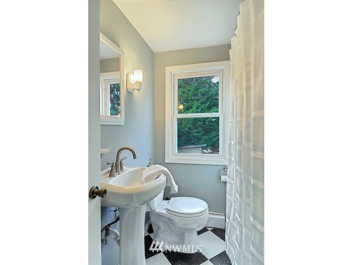 5326 South Hazel Street Seattle, WA 98178 - Photo 9 of 13 a bathroom with a toilet sink and mirror