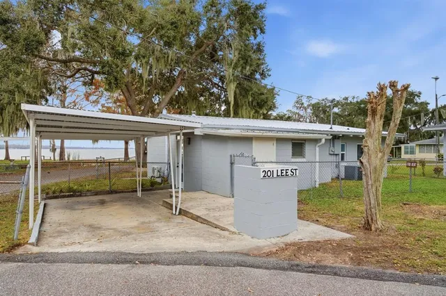 a view of a house with a yard and garage