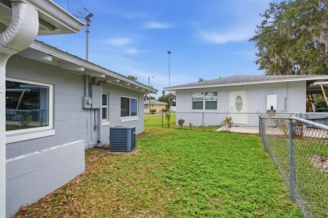 a front view of a house with a yard and outdoor seating