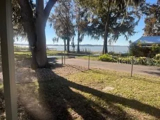 a view of a yard with wooden fence