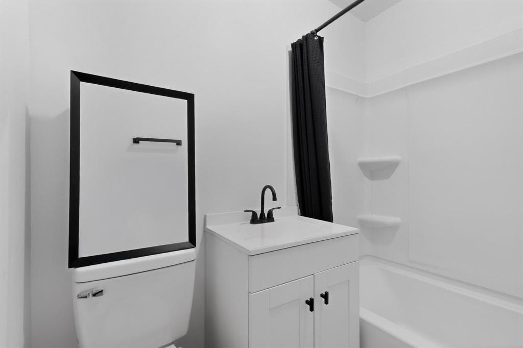 313 Farm To Market 316 Eustace, TX 75124 - Photo 24 of 33 a bathroom with a shower sink and mirror