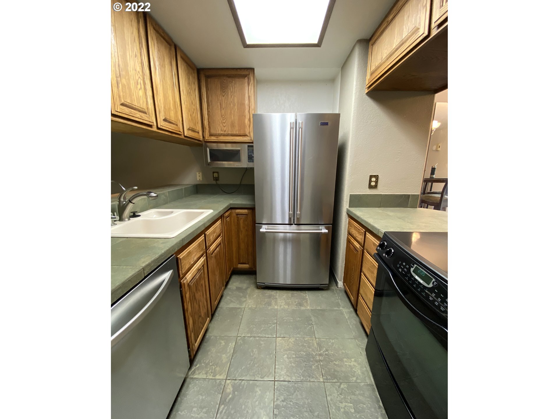 43605 Highway 38, Unit 24 Reedsport, OR 97467 - Photo 12 of 27 a kitchen with stainless steel appliances granite countertop a sink stove and refrigerator