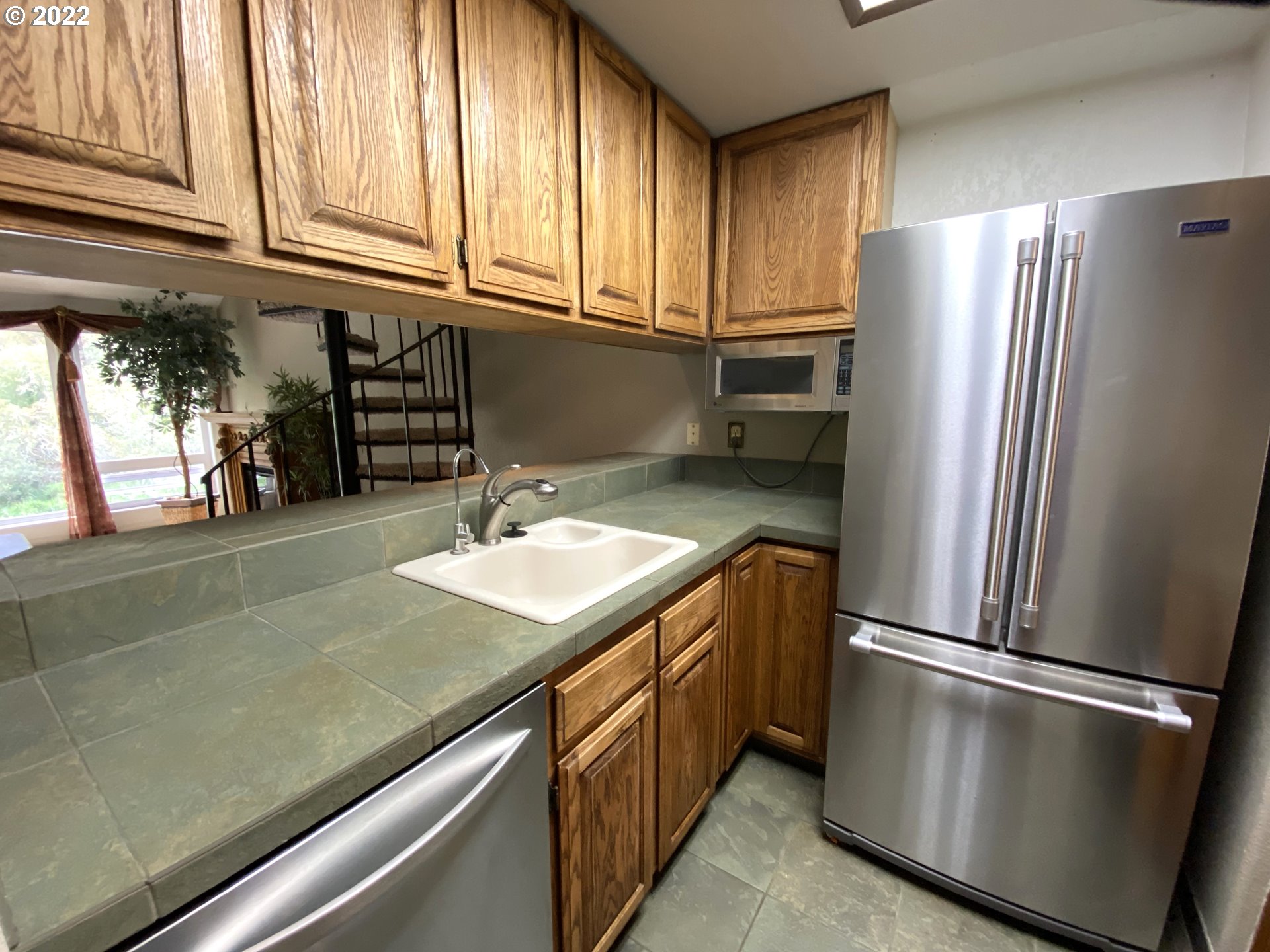43605 Highway 38, Unit 24 Reedsport, OR 97467 - Photo 13 of 27 a kitchen with stainless steel appliances granite countertop a refrigerator a sink and a stove