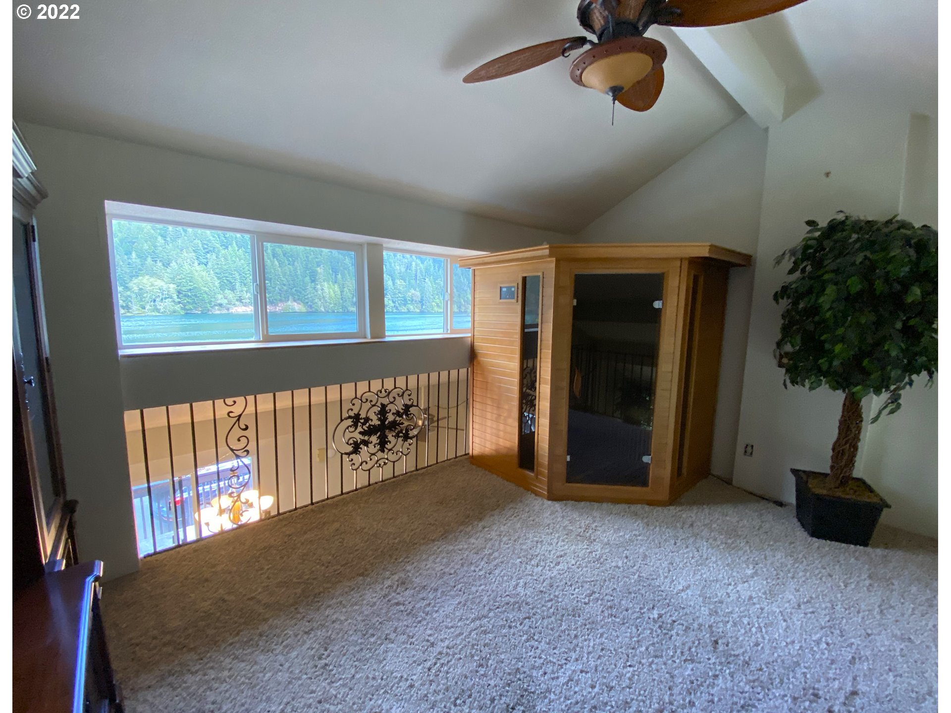 43605 Highway 38, Unit 24 Reedsport, OR 97467 - Photo 19 of 27 a view of an empty room and window with a chandelier fan