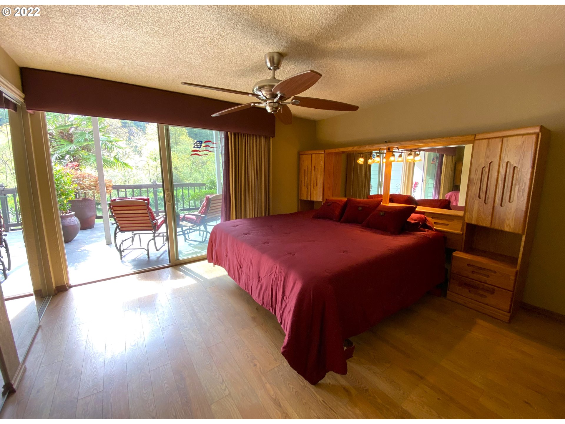 43605 Highway 38, Unit 24 Reedsport, OR 97467 - Photo 22 of 27 a spacious bedroom with a large bed and a chandelier