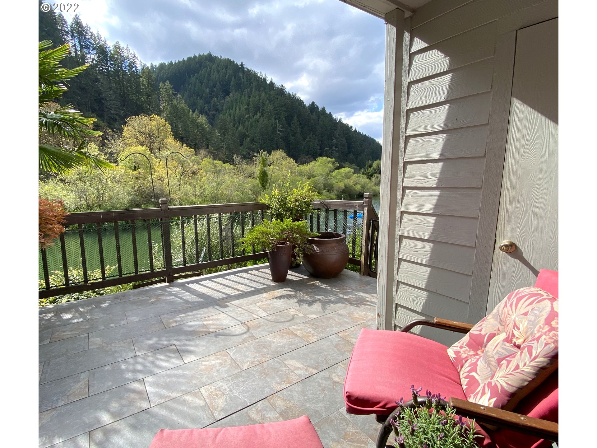 43605 Highway 38, Unit 24 Reedsport, OR 97467 - Photo 24 of 27 a view of a patio with a table chairs and a potted plant
