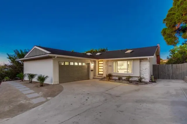a view of a house with a yard and garage