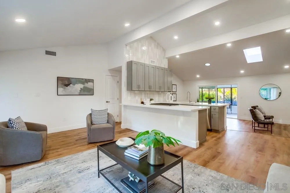 4793 54th Street San Diego, CA 92115 - Photo 17 of 74 a living room with kitchen couches and kitchen view with wooden floor