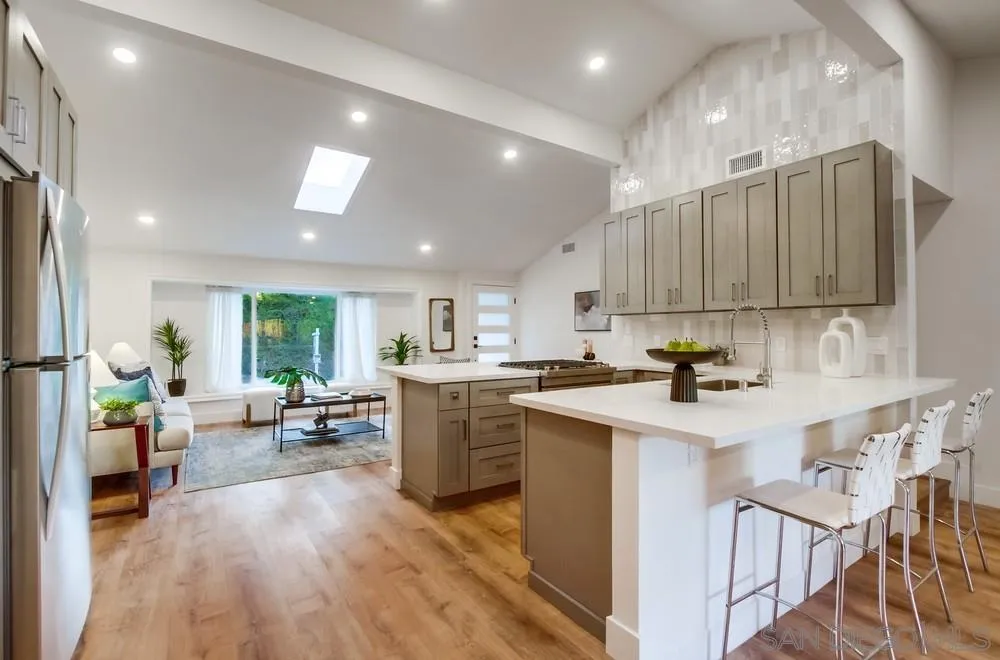 4793 54th Street San Diego, CA 92115 - Photo 25 of 74 a kitchen with sink cabinets and wooden floor