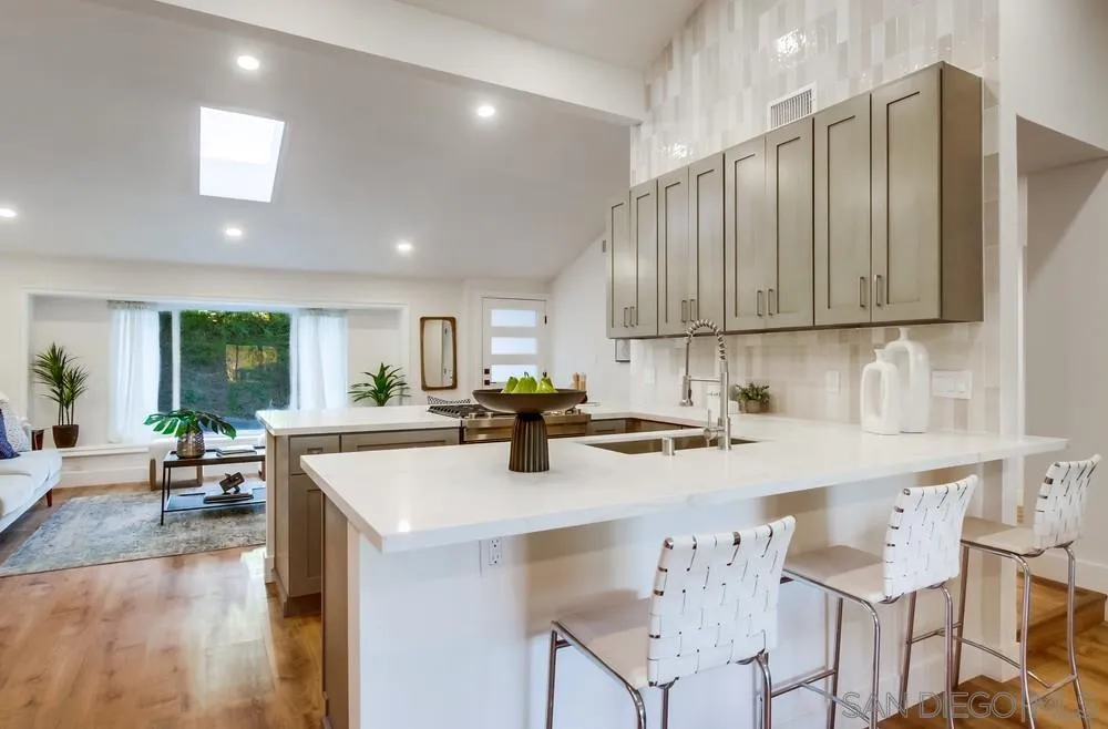4793 54th Street San Diego, CA 92115 - Photo 26 of 74 a kitchen with a sink cabinets and wooden floor