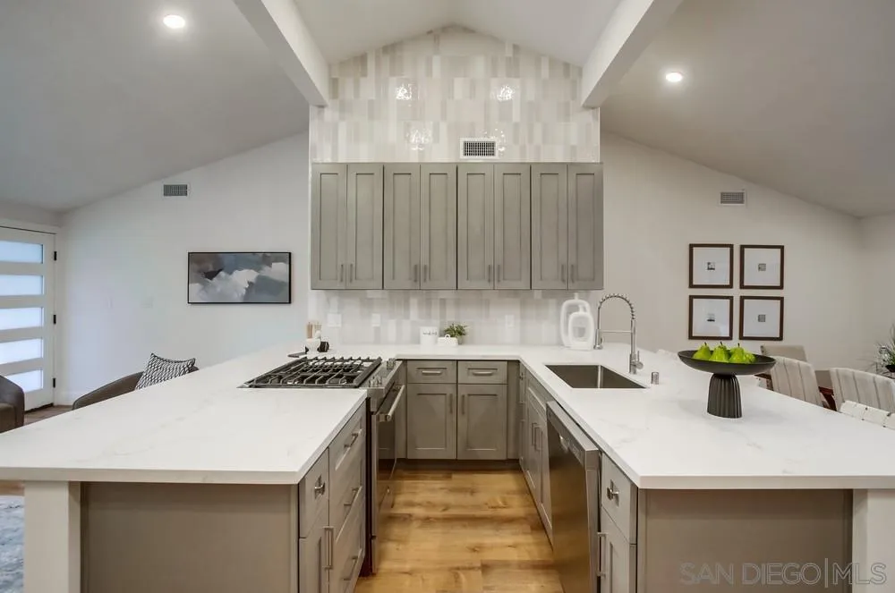 4793 54th Street San Diego, CA 92115 - Photo 27 of 74 a kitchen that has a sink and a stove in it